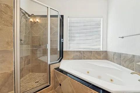 a bathroom with a bathtub and shower