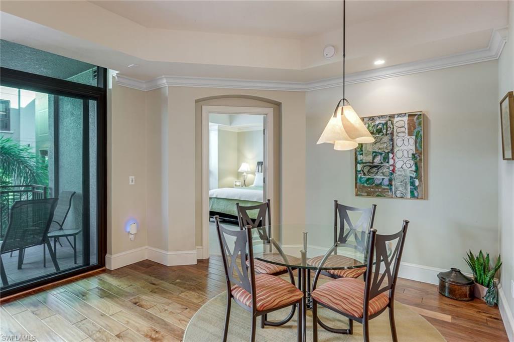 9123 Strada Place, Unit 7201 Naples, FL 34108 - Photo 10 of 50 a view of a dining room with furniture and wooden floor