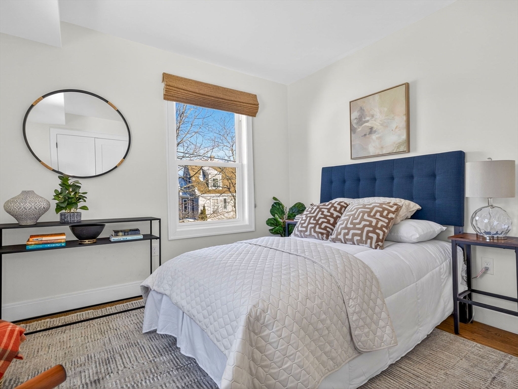 25 Cranston Street, Unit 2 Boston, MA 02130 - Photo 17 of 41 a bedroom with a bed a mirror and a potted plant
