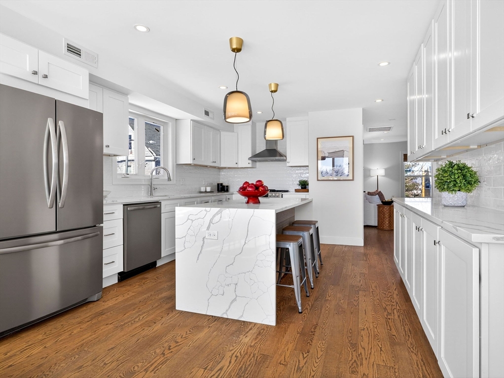 25 Cranston Street, Unit 2 Boston, MA 02130 - Photo 3 of 41 a kitchen with stainless steel appliances granite countertop a refrigerator a stove oven a sink dishwasher and white cabinets with wooden floor