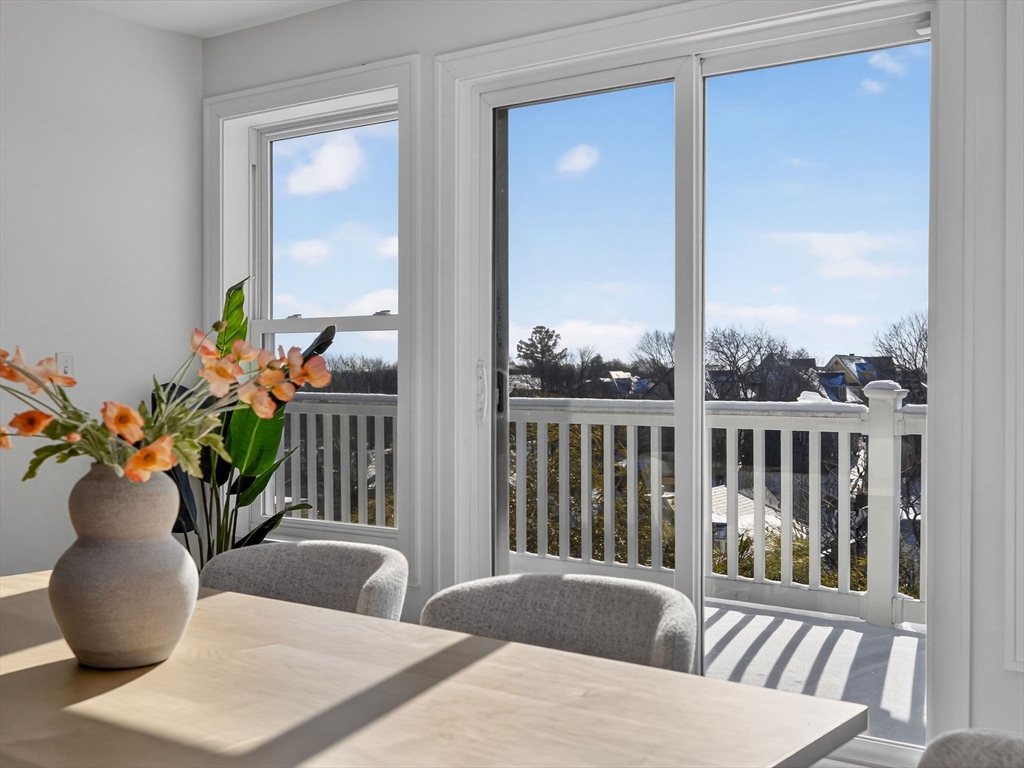 25 Cranston Street, Unit 2 Boston, MA 02130 - Photo 8 of 41 a dining room with furniture potted plants and wooden floor