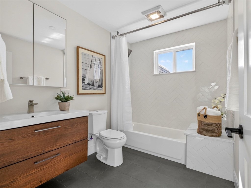 25 Cranston Street, Unit 2 Boston, MA 02130 - Photo 10 of 41 a bathroom with a toilet a sink and mirror