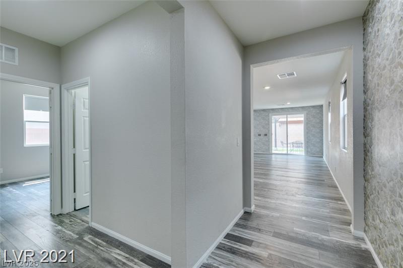 5475 Ordesa Valley Road Las Vegas, NV 89148 - Photo 35 of 35 Step into a hallway featuring elegant plank flooring and a welcoming open floorplan.