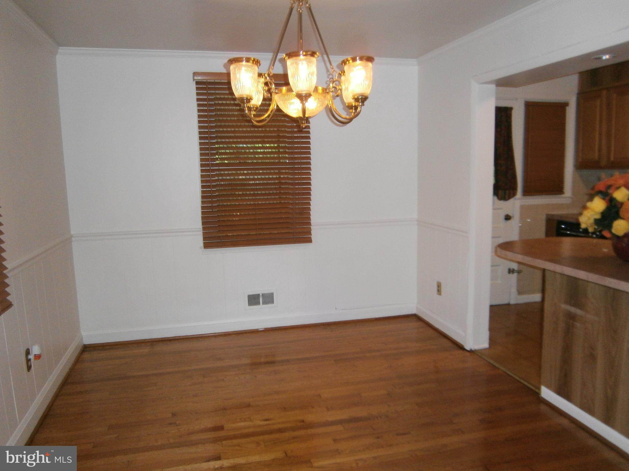 432 South Wickham Road Baltimore, MD 21229 - Photo 8 of 29 a view of a room with wooden floor and painted walls