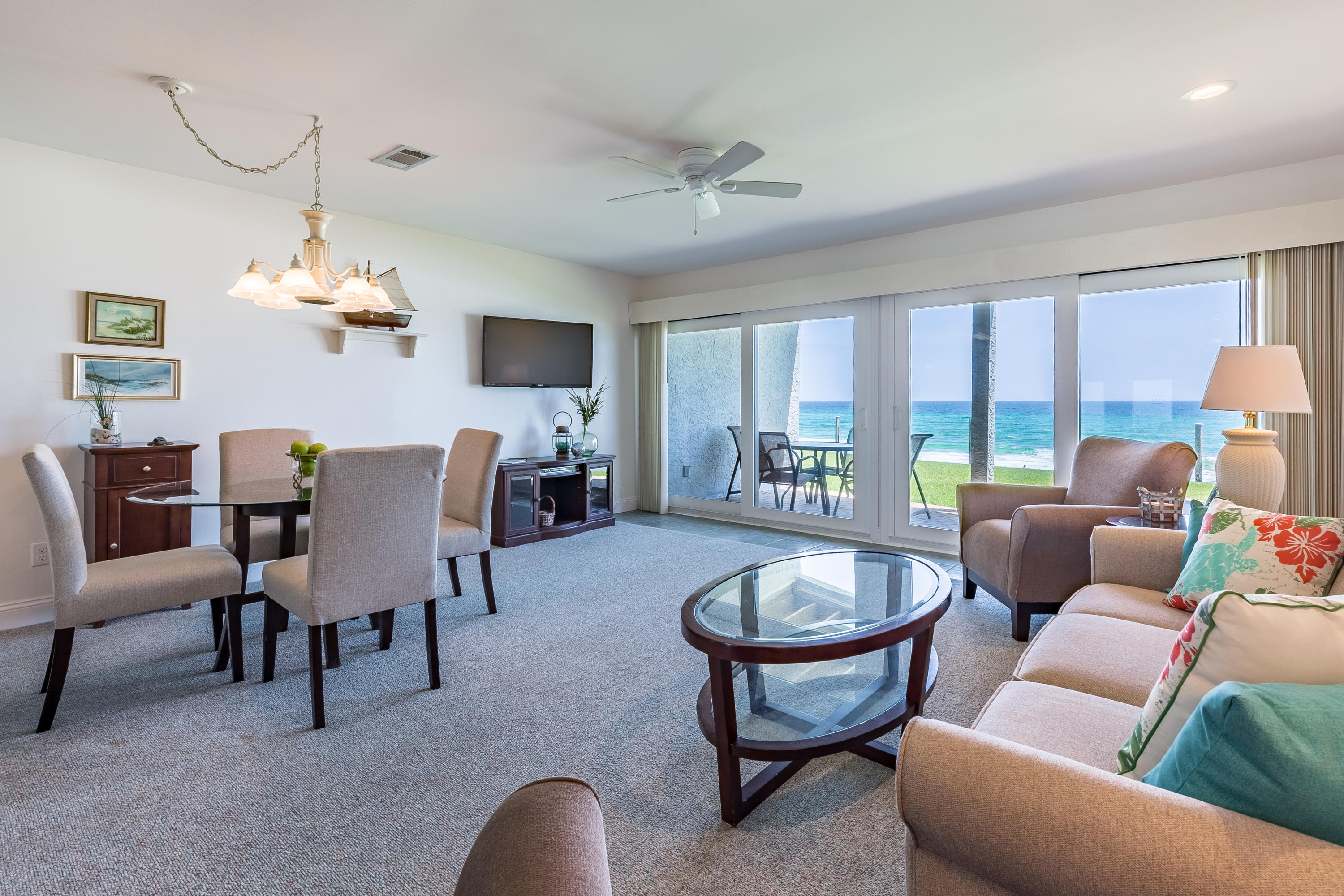 214 Blue Mountain Road, Unit 14 Santa Rosa Beach, FL 32459 - Photo 1 of 24 a living room with furniture a chandelier and a flat screen tv
