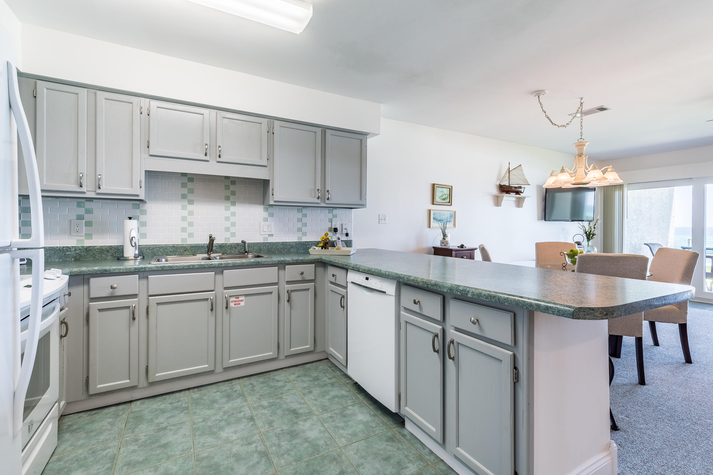 214 Blue Mountain Road, Unit 14 Santa Rosa Beach, FL 32459 - Photo 10 of 24 a kitchen with cabinets appliances and a center island