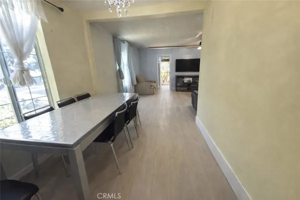 a view of a hallway with furniture and a window