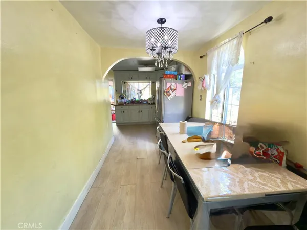 a dining room with furniture and a chandelier