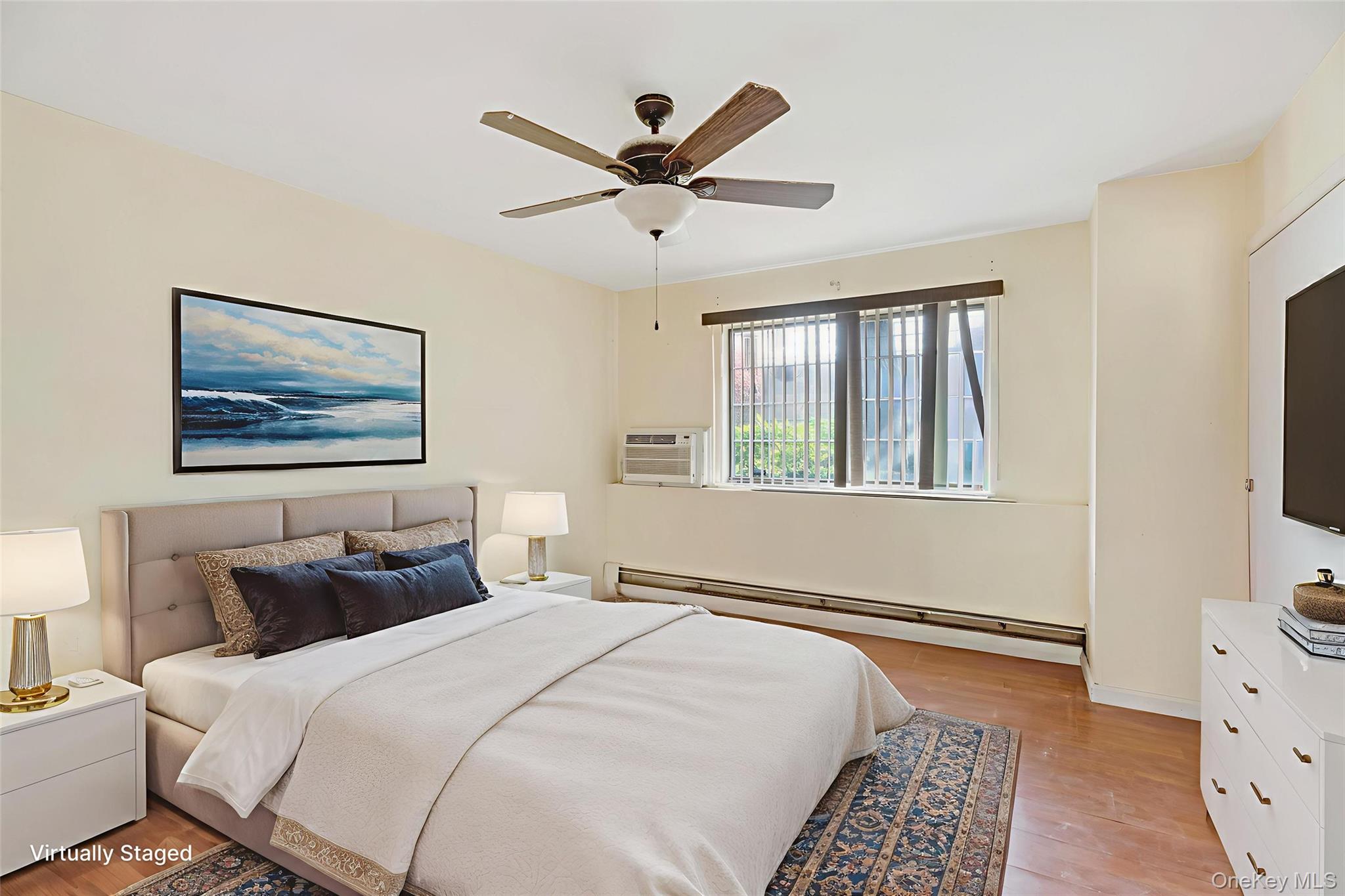 155 A Devon Loop Staten Island, NY 10314 - Photo 5 of 8 Bedroom with light wood-type flooring, a baseboard radiator, and ceiling fan