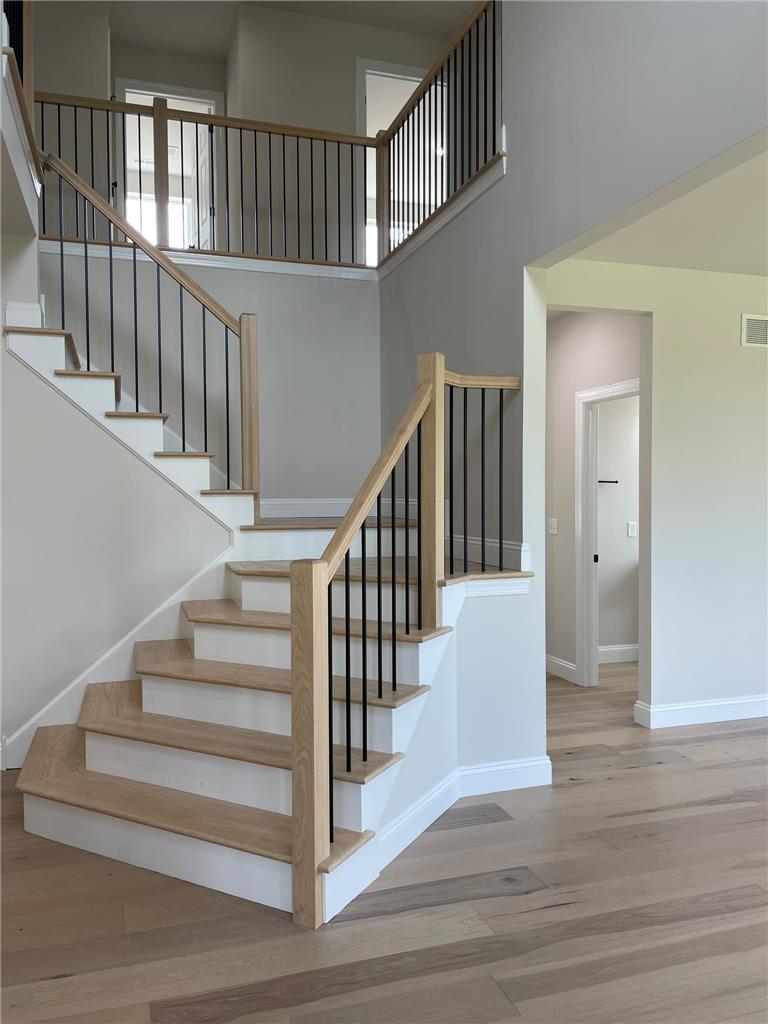 5043 Chapmans Road Orefield, PA 18069 - Photo 4 of 30 Natural light illuminates the elegant hardwood flooring and contemporary staircase with black wrought iron spindles.