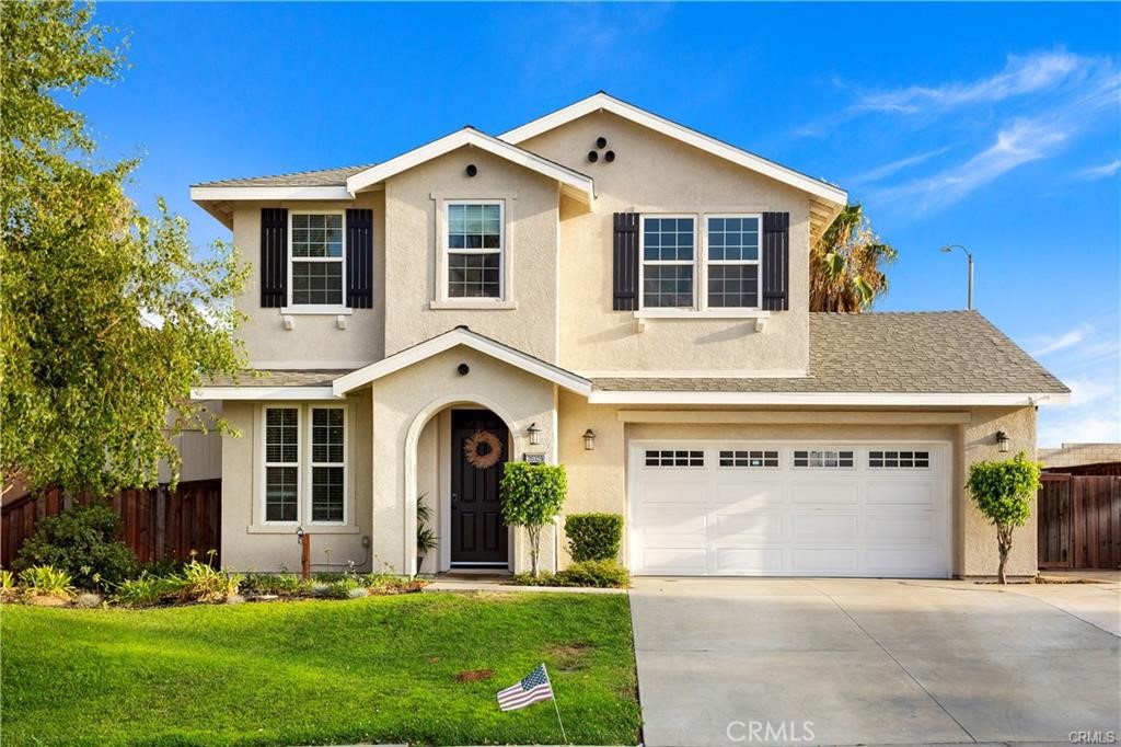 20329 Red Poppy Lane Riverside, CA 92508 - Photo 1 of 1 a view of white house with a yard and garage