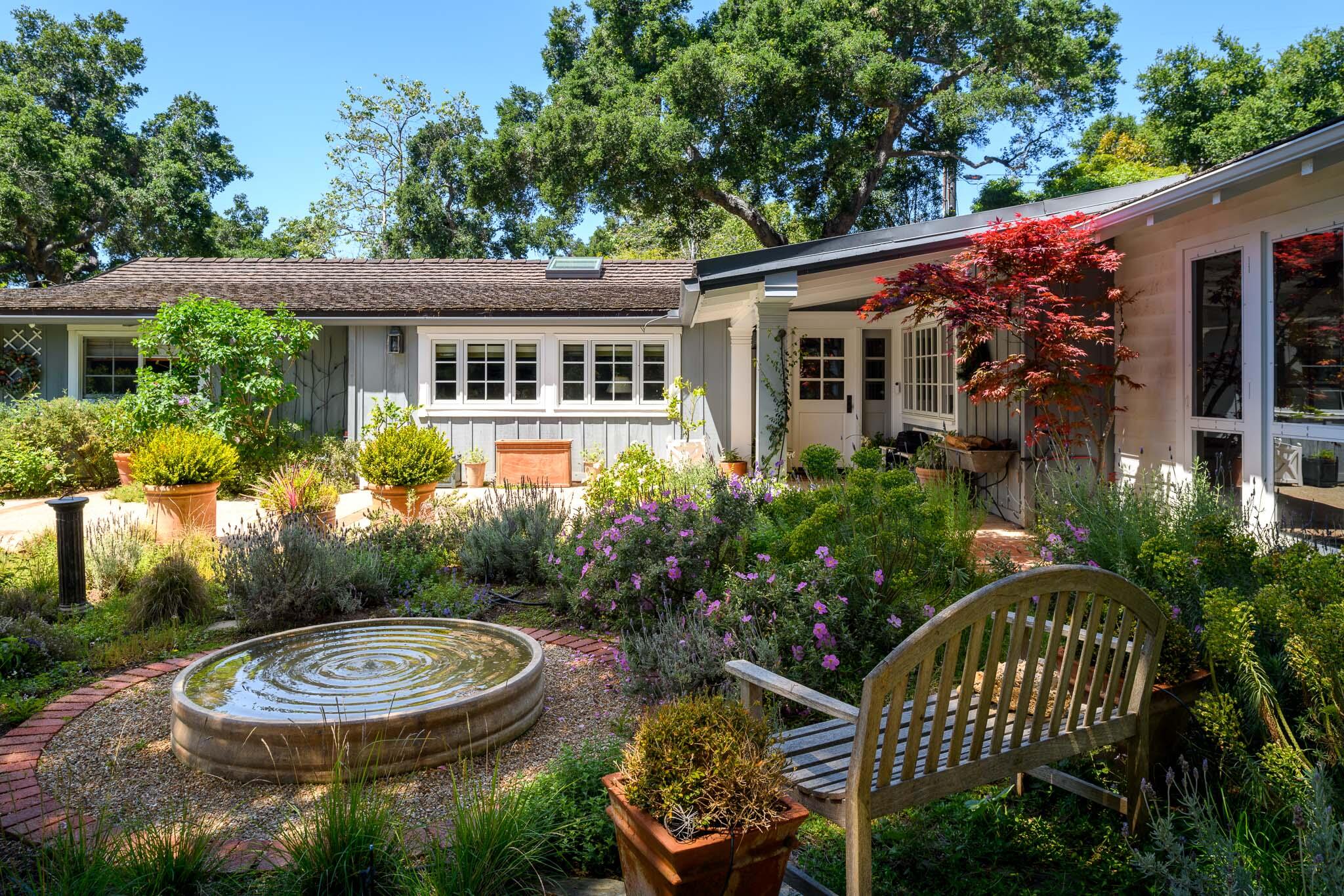 2868 East Valley Road Montecito, CA 93108 - Photo 3 of 34 a view of a chair and table in backyard of the house