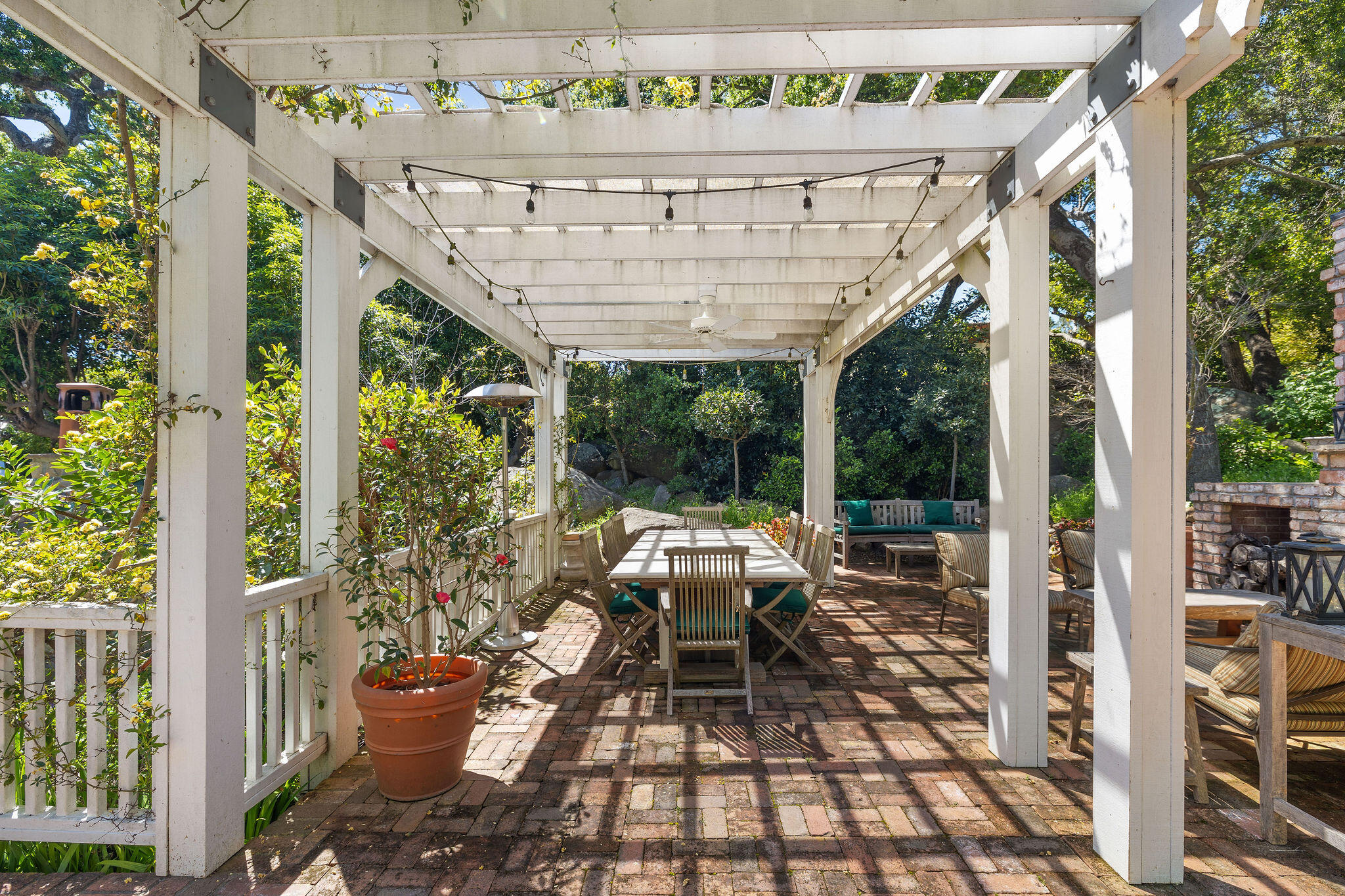 2868 East Valley Road Montecito, CA 93108 - Photo 31 of 34 a view of a patio with table and chairs potted plants with floor to ceiling window