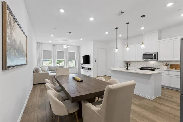a large kitchen with a table and chairs