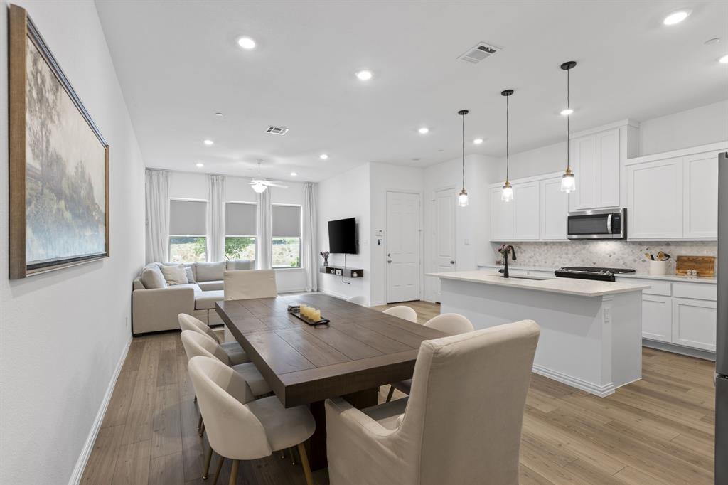 3014 Opera Way Sachse, TX 75048 - Photo 13 of 35 a large kitchen with a table and chairs