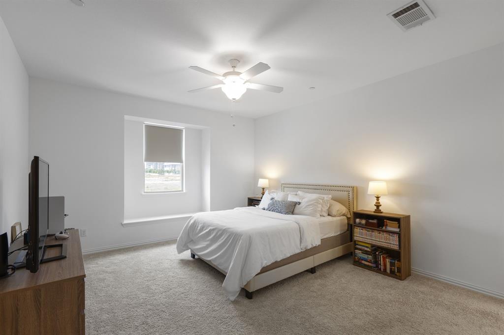 3014 Opera Way Sachse, TX 75048 - Photo 21 of 35 a bedroom with a bed and a flat tv screen on a dresser
