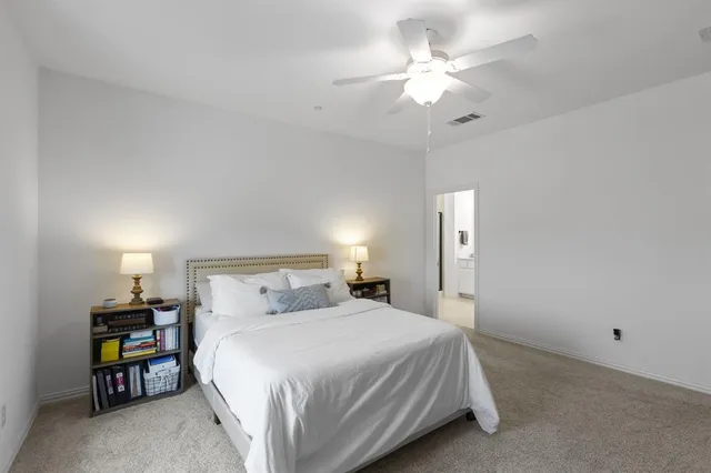 a bedroom with a bed and a ceiling fan
