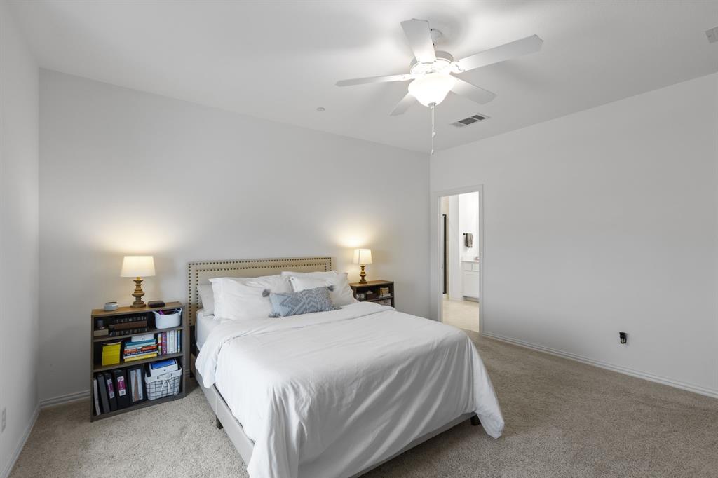 3014 Opera Way Sachse, TX 75048 - Photo 22 of 35 a bedroom with a bed and a ceiling fan