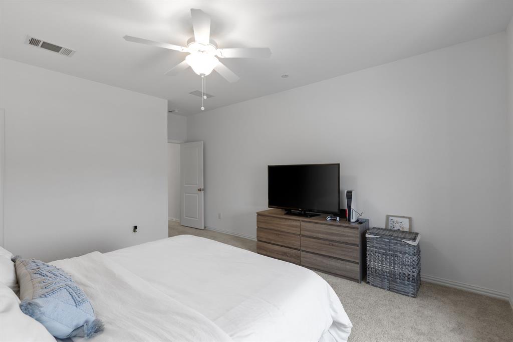 3014 Opera Way Sachse, TX 75048 - Photo 23 of 35 a bedroom with a bed and a flat screen tv