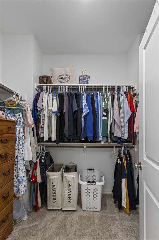3014 Opera Way Sachse, TX 75048 - Photo 26 of 35 a view of walk in closet with clothes and shoes