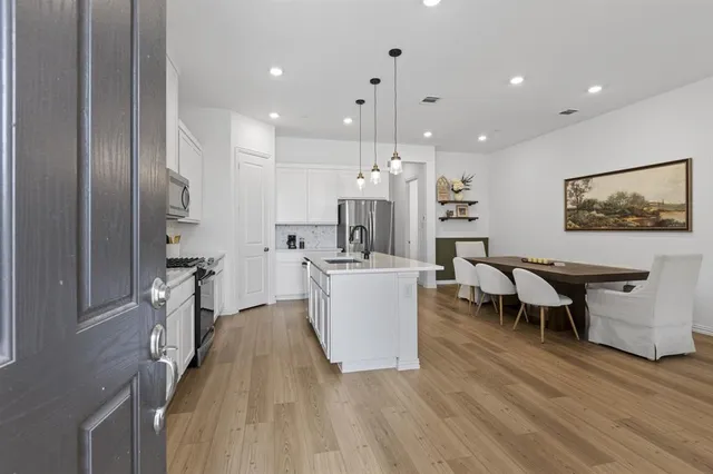 a large kitchen with a table and chairs in it