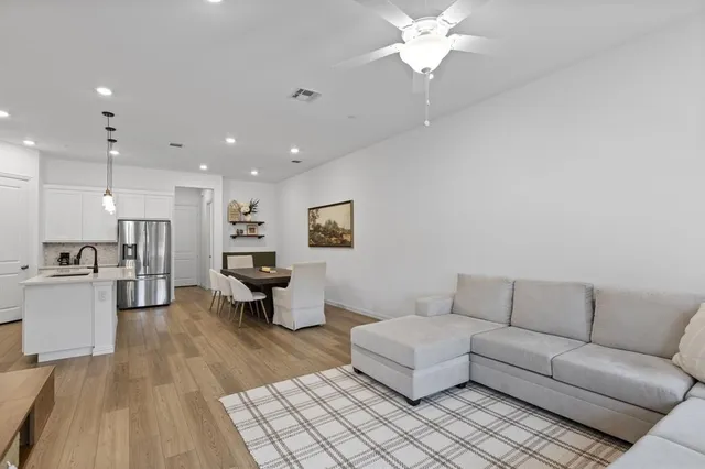 a living room with furniture and kitchen view