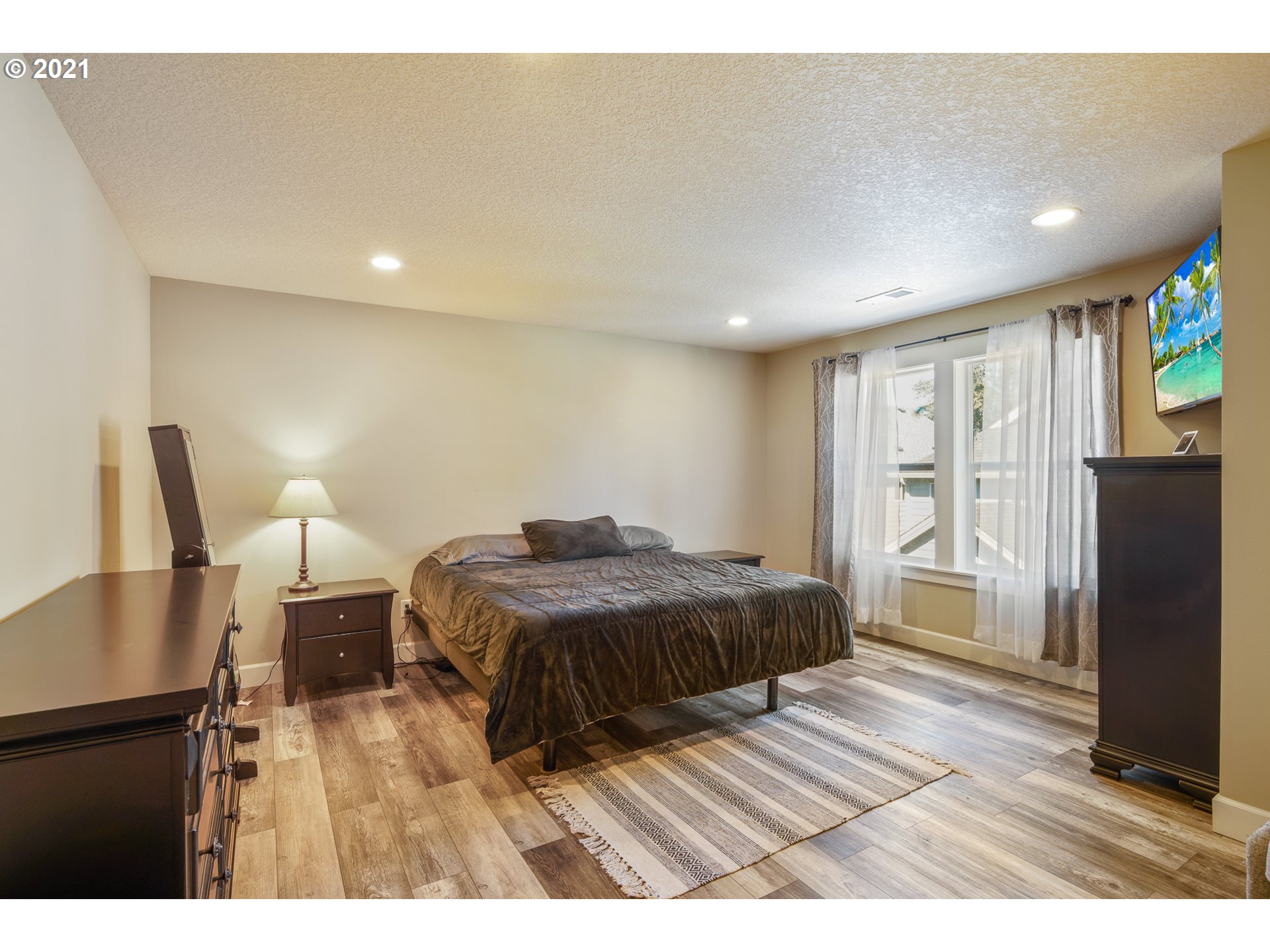 1292 South Quail Run Place Ridgefield, WA 98642 - Photo 22 of 30 a bedroom with a bed and wooden floor
