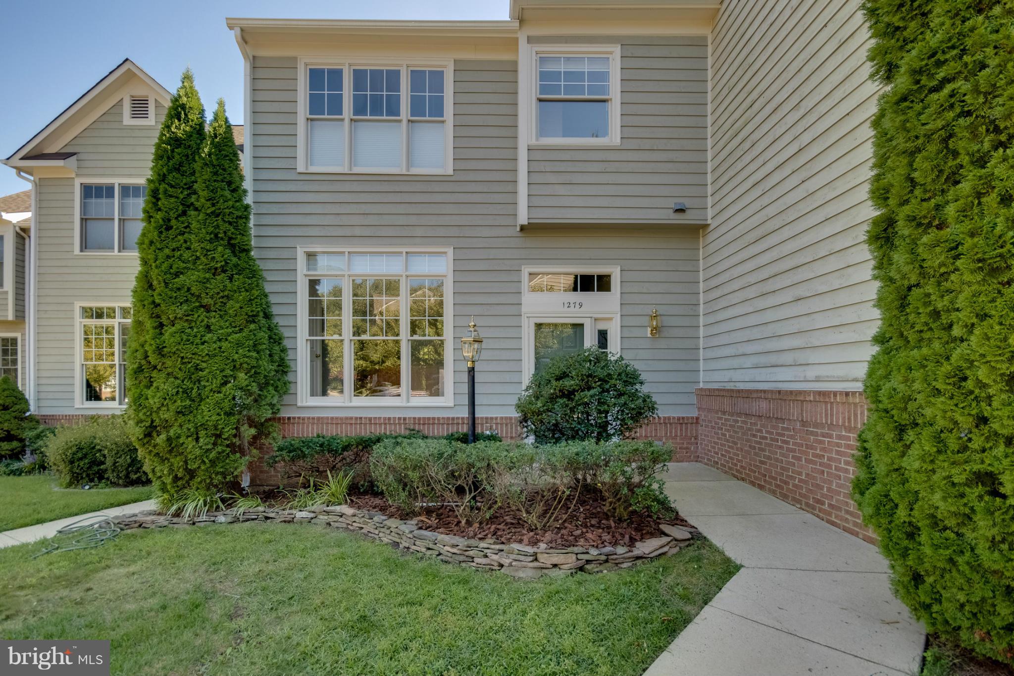 1279 Weatherstone Court Reston, VA 20194 - Photo 1 of 28 a front view of a house with a garden