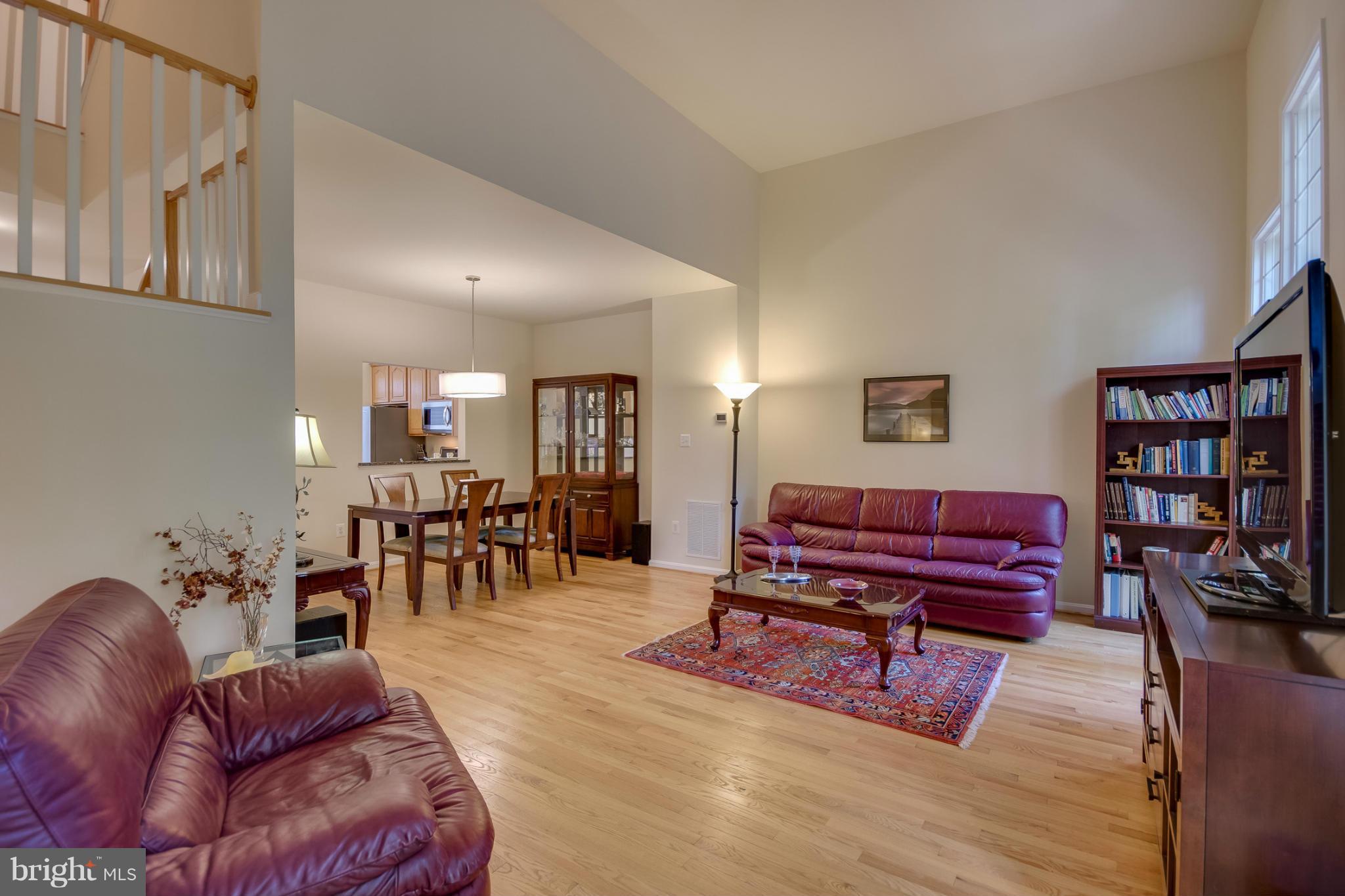 1279 Weatherstone Court Reston, VA 20194 - Photo 12 of 28 a living room with furniture and a book shelf
