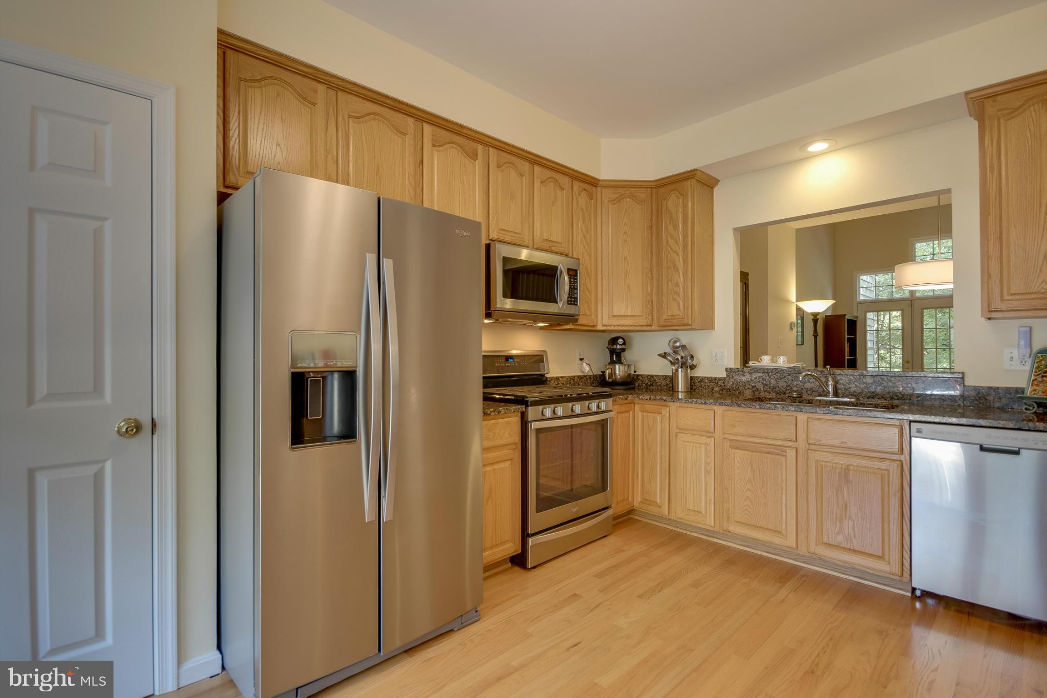 1279 Weatherstone Court Reston, VA 20194 - Photo 14 of 28 a kitchen with granite countertop a refrigerator stove top oven and sink