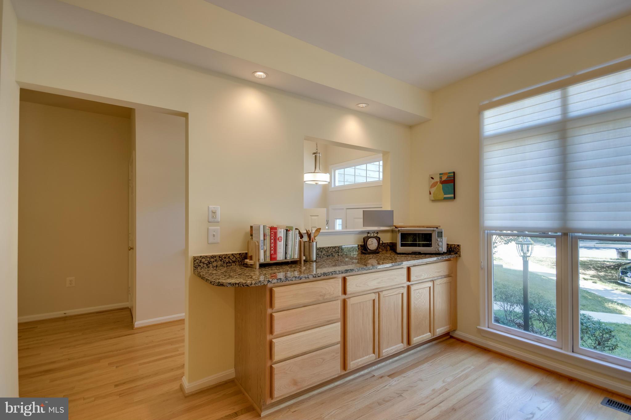 1279 Weatherstone Court Reston, VA 20194 - Photo 15 of 28 a kitchen with stainless steel appliances granite countertop a sink stove and wooden floor