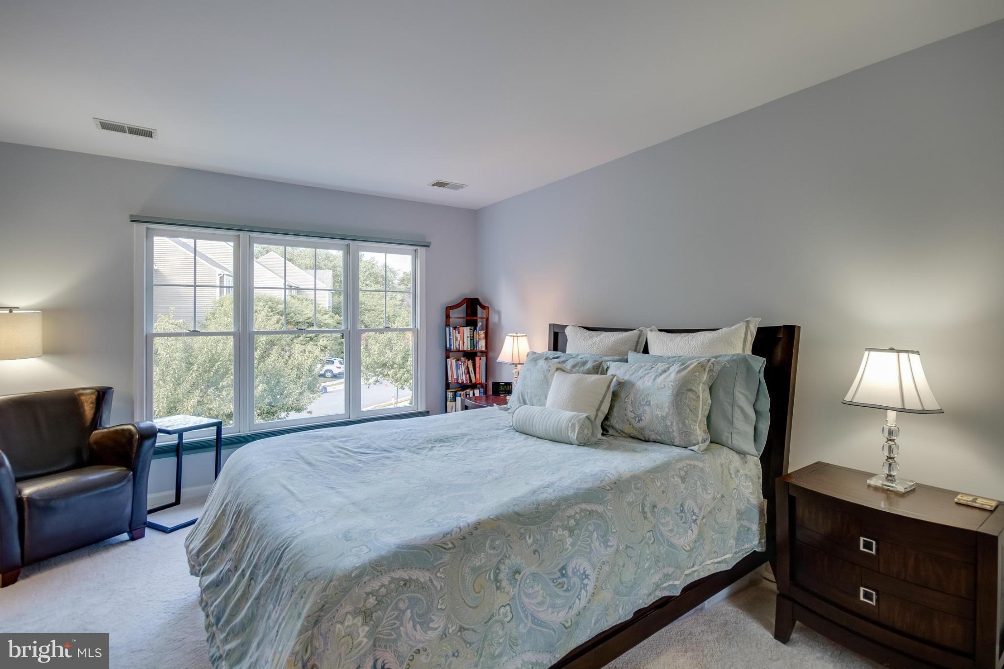 1279 Weatherstone Court Reston, VA 20194 - Photo 16 of 28 a bedroom with a bed and a couch