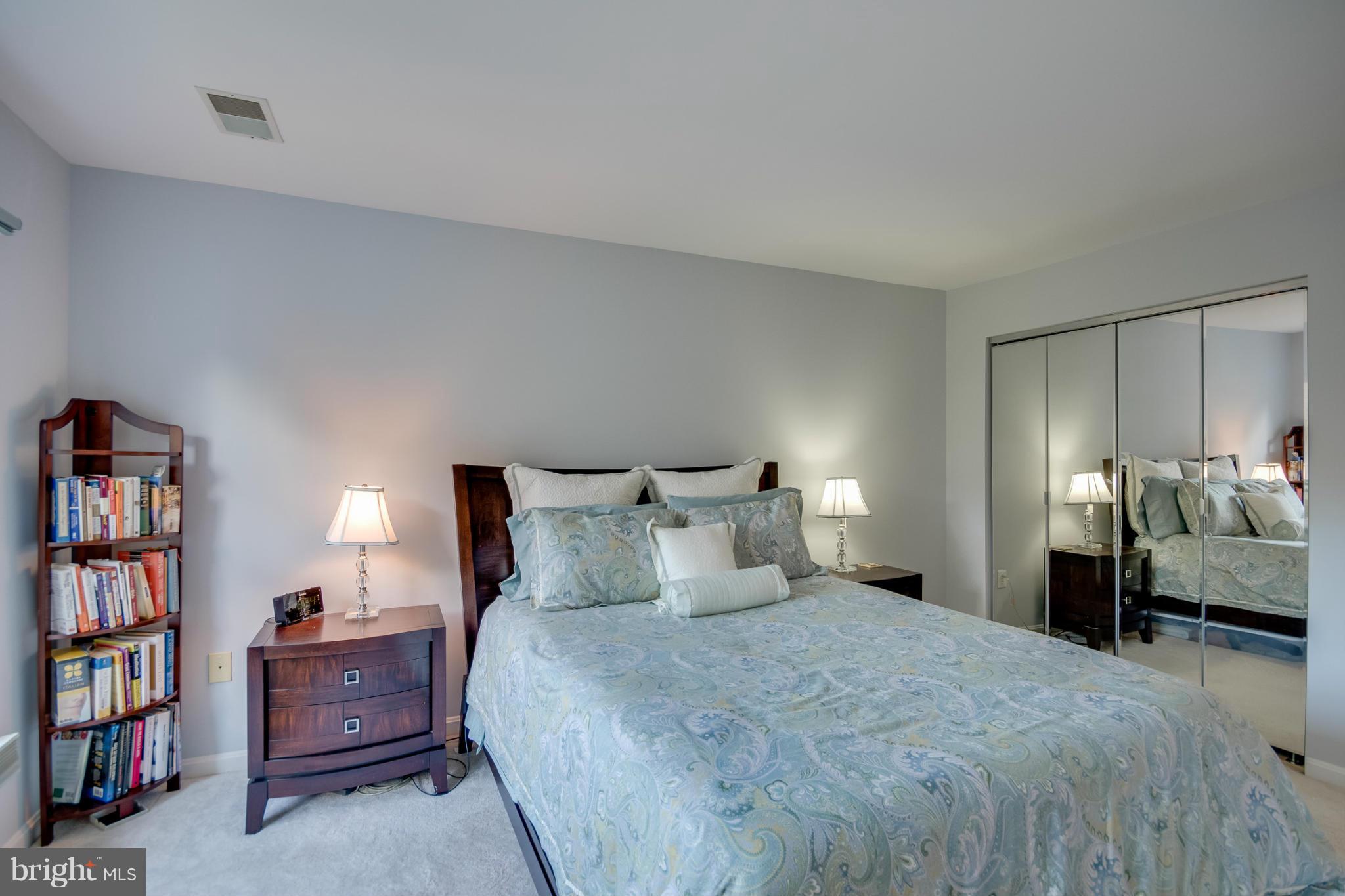 1279 Weatherstone Court Reston, VA 20194 - Photo 17 of 28 a bedroom with a bed and a book shelf
