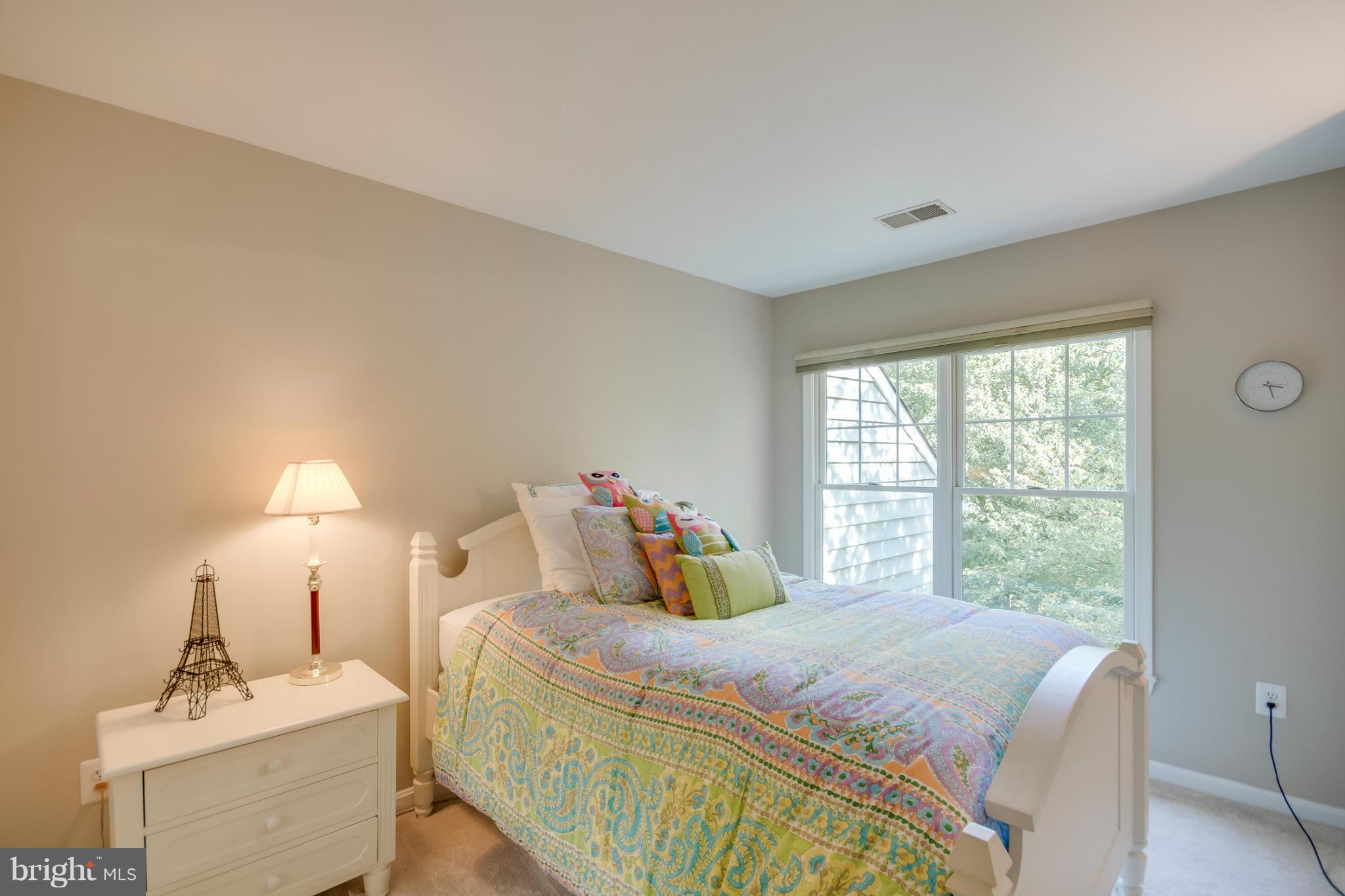 1279 Weatherstone Court Reston, VA 20194 - Photo 21 of 28 a bedroom with a bed and a lamp