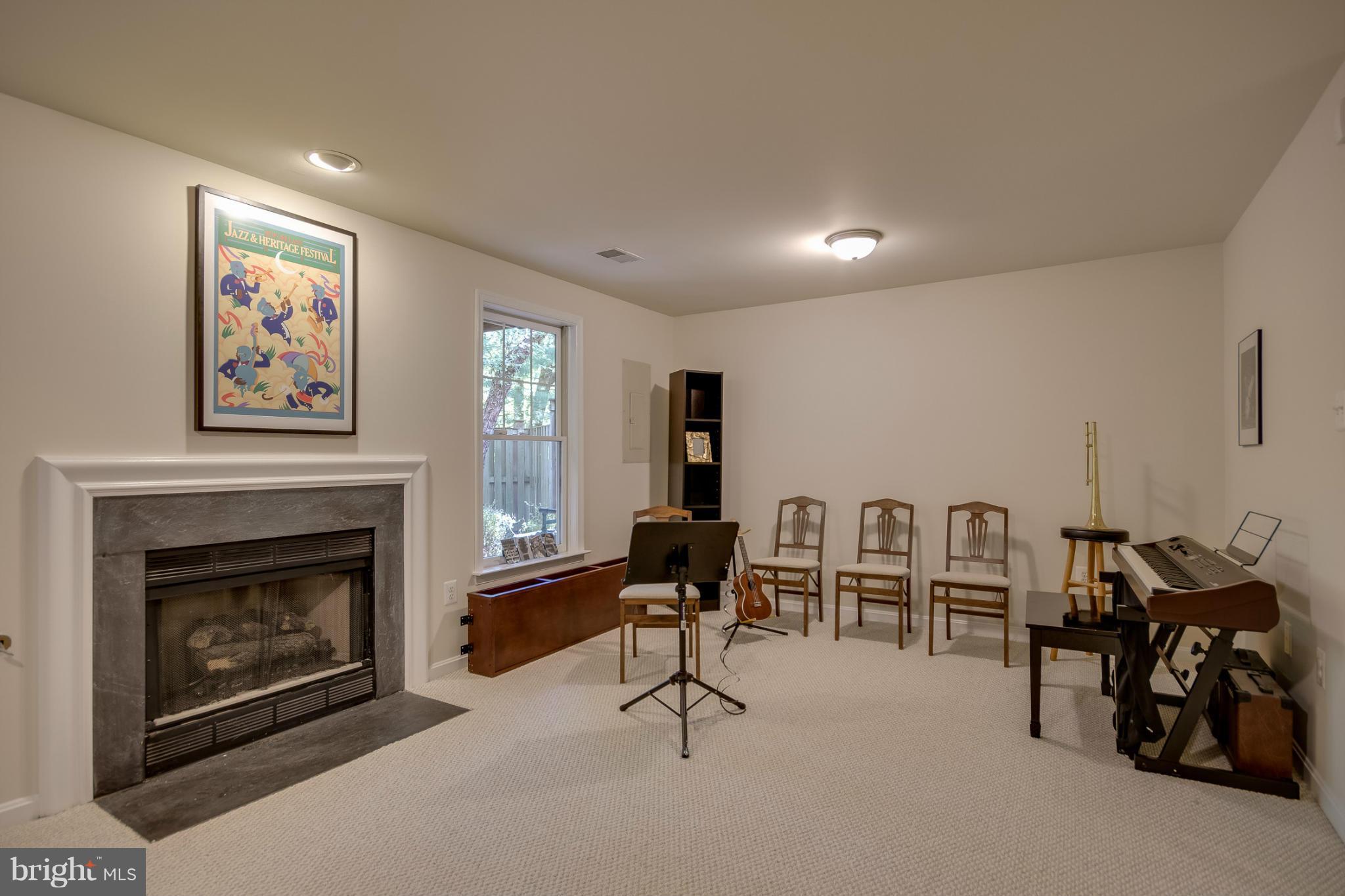 1279 Weatherstone Court Reston, VA 20194 - Photo 24 of 28 a living room with furniture gym equipment and a fireplace