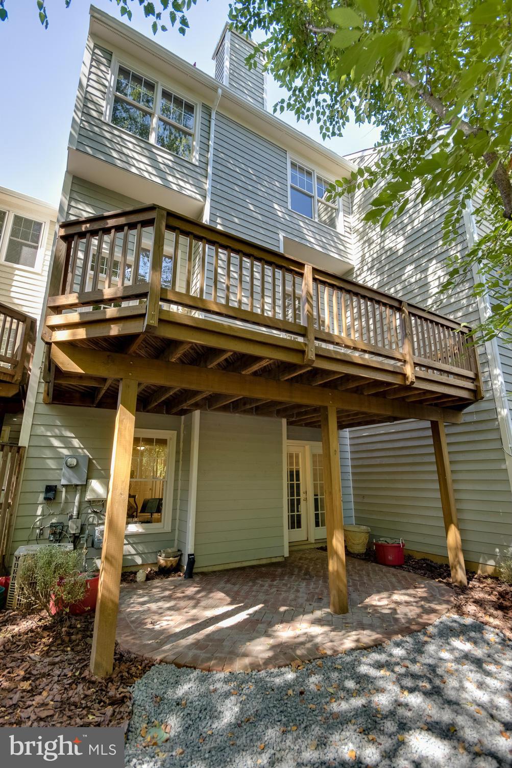 1279 Weatherstone Court Reston, VA 20194 - Photo 26 of 28 a view of a house with a patio and wooden fence