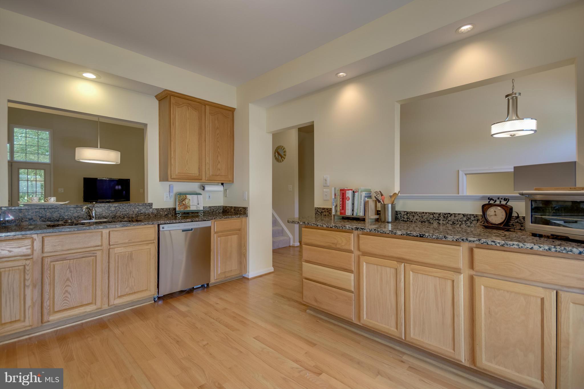 1279 Weatherstone Court Reston, VA 20194 - Photo 4 of 28 a kitchen with granite countertop white cabinets and white appliances