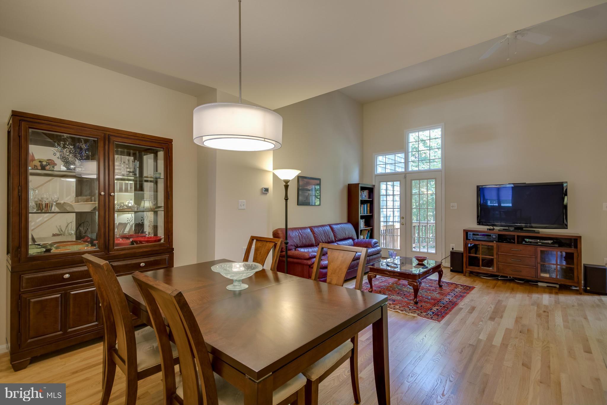 1279 Weatherstone Court Reston, VA 20194 - Photo 6 of 28 a living room with furniture and a flat screen tv