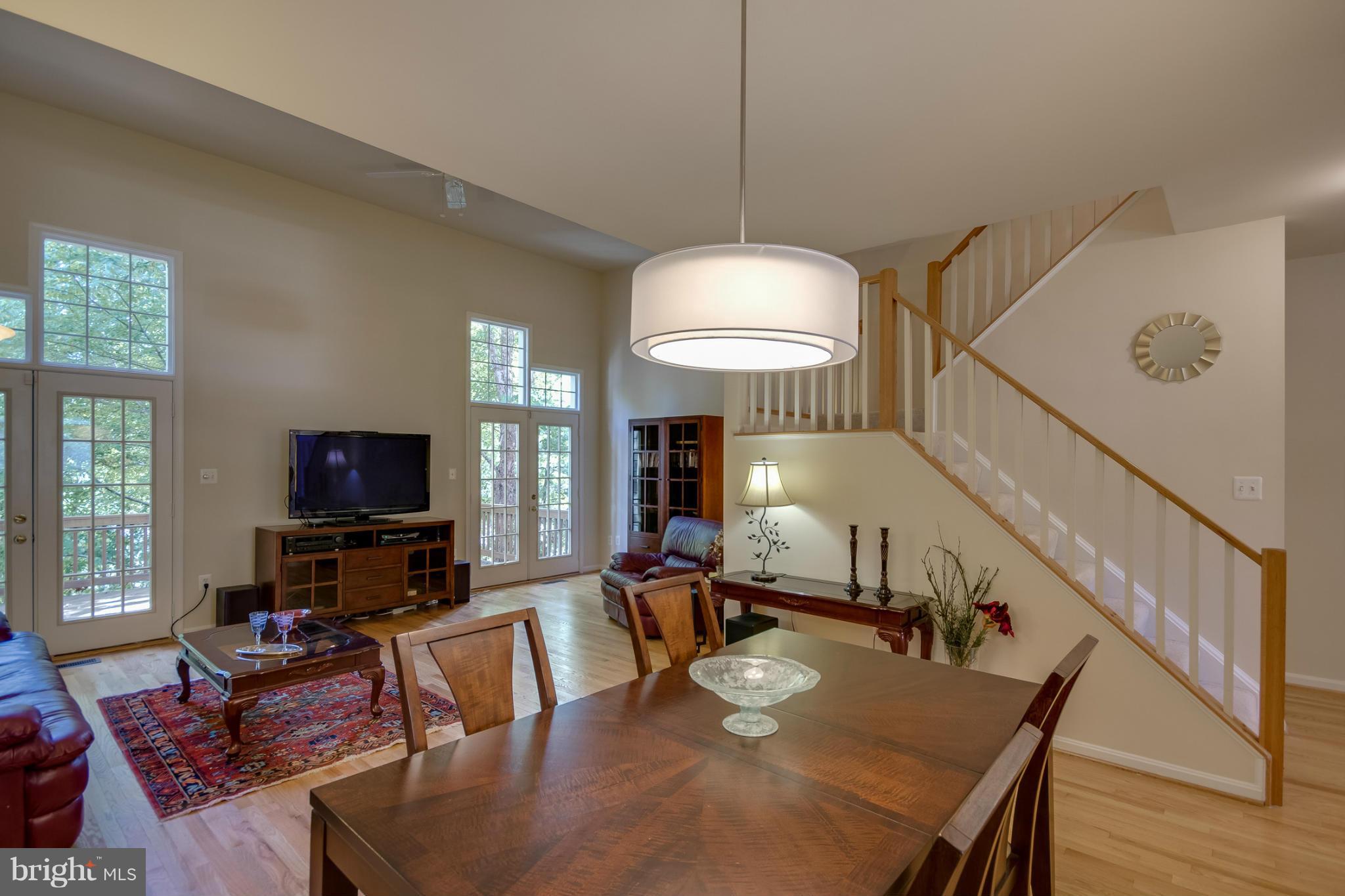 1279 Weatherstone Court Reston, VA 20194 - Photo 7 of 28 a living room with furniture a window and a flat screen tv