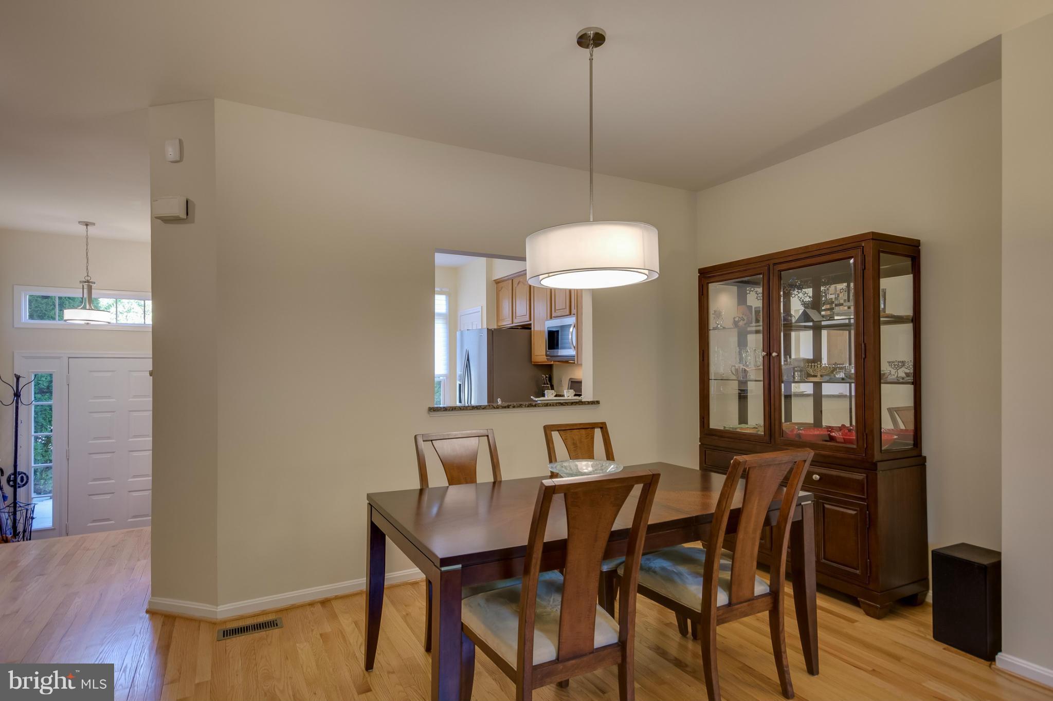 1279 Weatherstone Court Reston, VA 20194 - Photo 8 of 28 a view of a dining room with furniture window and wooden floor
