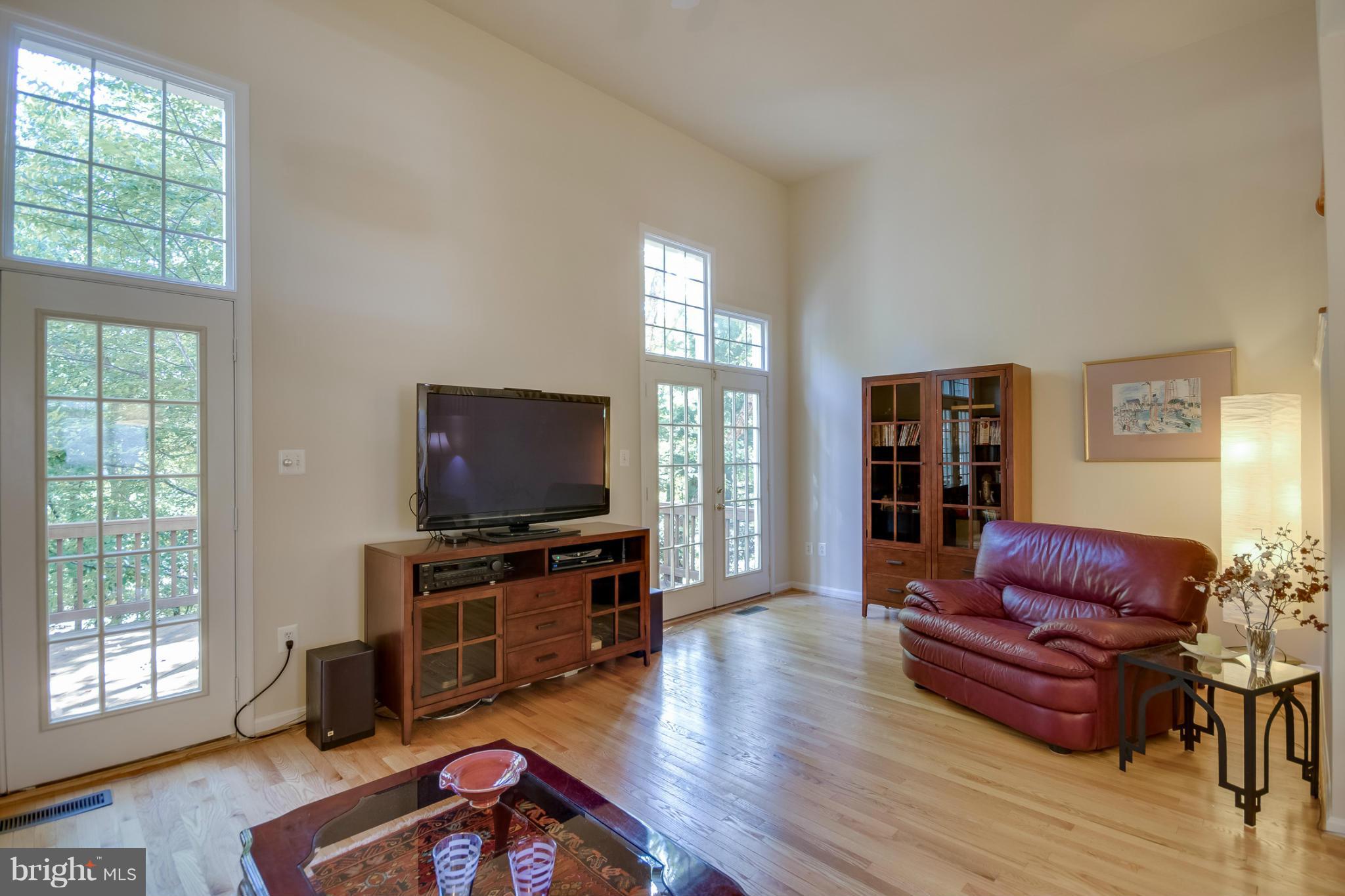 1279 Weatherstone Court Reston, VA 20194 - Photo 9 of 28 a living room with furniture and a flat screen tv
