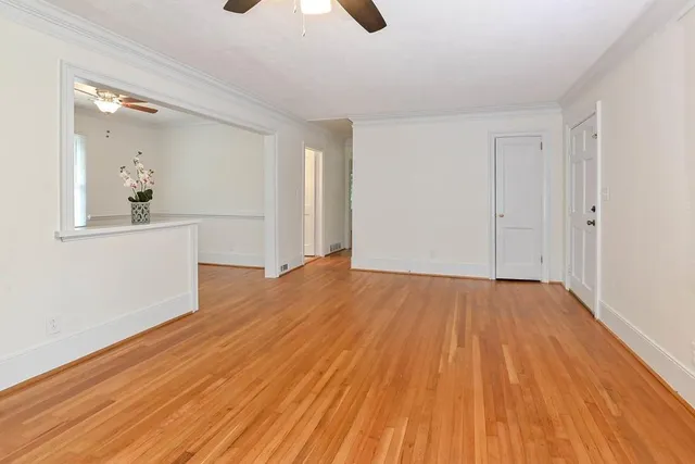 a view of a room with wooden floor and white walls