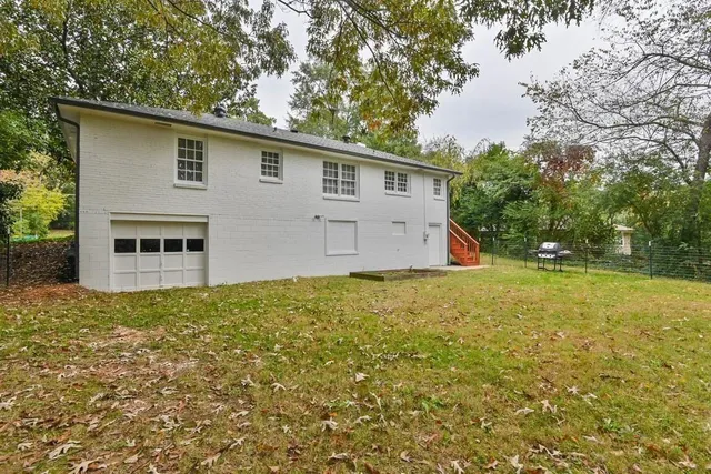 a view of a backyard with large trees