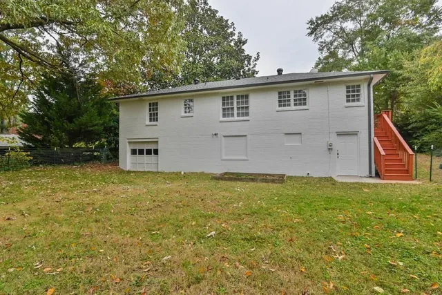 a view of a backyard with large trees