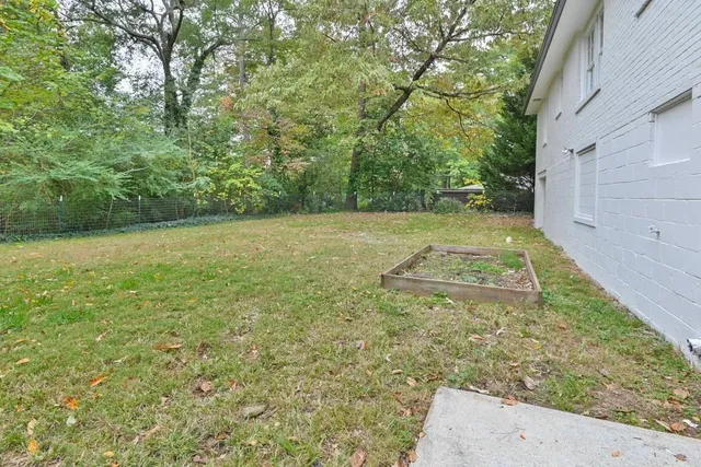 a view of a field with trees in the background