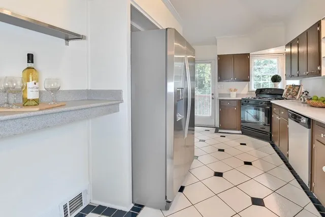 a kitchen with stainless steel appliances a refrigerator sink and cabinets