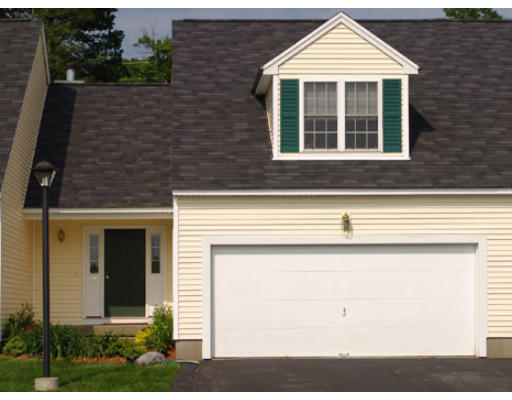 29 Cold Spring Drive, Unit B Sutton, MA 01590 - Photo 1 of 1 a front view of a house with a yard and garage