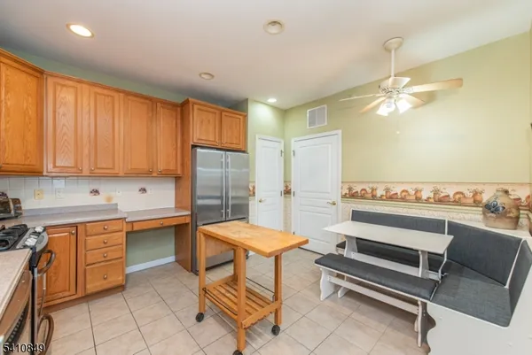 a view of a livingroom with a ceiling fan and window