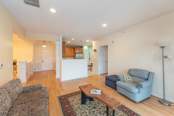 a living room with furniture and view of kitchen
