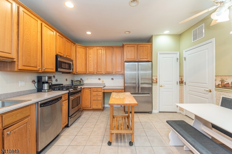 10323 Warren's Way Wanaque, NJ 07465 - Photo 9 of 30 a large kitchen with a large window and stainless steel appliances